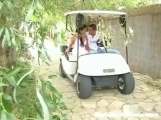 A schoolgirl and her lover are driving around in a golf cart. Suddenly they stop and the fellow sets up to touch the girl up,