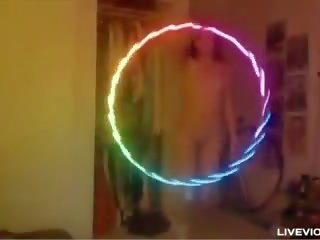 Nerdy redhead diva Lana twirls a luminous hula-hoop and fucks her pussy